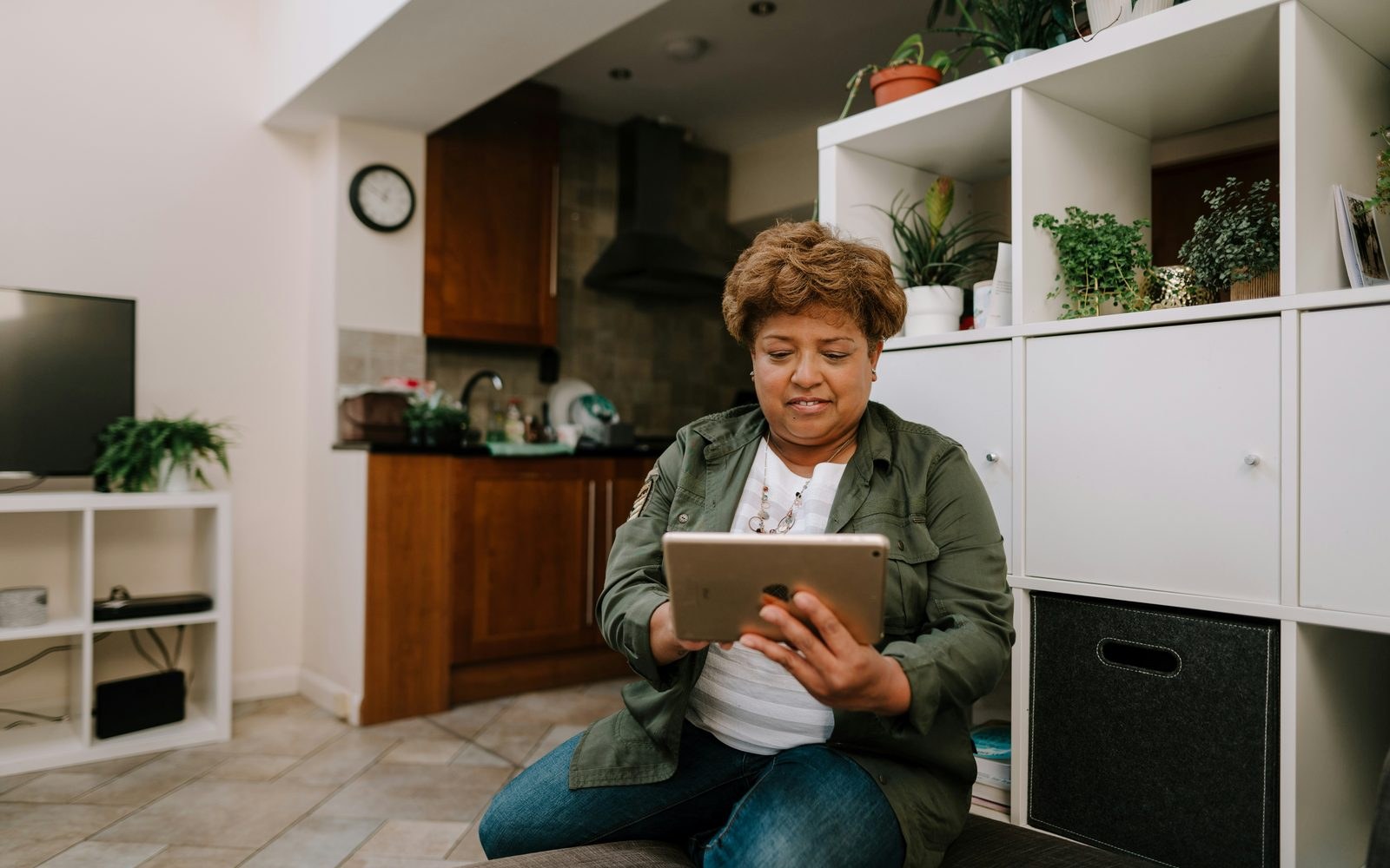 Carol at home, reading an email on her tablet