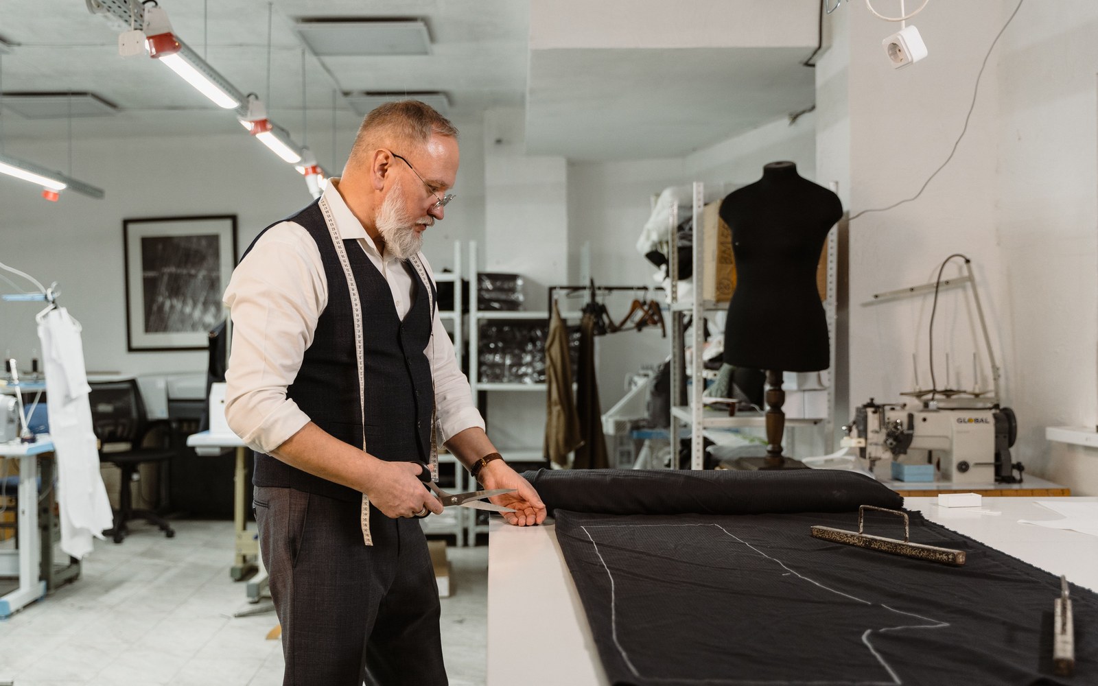 Ray on his shop floor, cutting to a pattern he laid out himself